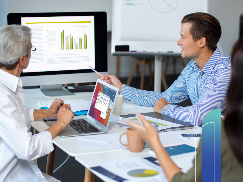 Professional team reviewing performance data on screen, representing the efficiency of the best virtual assistant systems for founders.